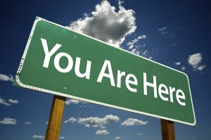 Dramatic Clouds Road Sign Stampe: You are here road sign with dramatic clouds and sky
