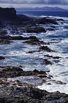 Canarian Coastline Stampe: Rough sea with waves hitting cliffs under cloudy sky