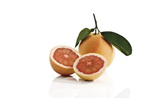 Orange Colored Fruits Stampe: Ruby Red grapefruit with stem and leaves