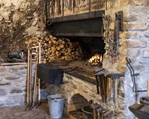 Traditional Craftsman Tools Stampe: A rustic blacksmith workshop featuring a burning forge
