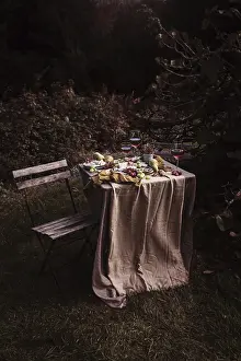 Fresh Fruit Arrangement Stampe: A rustic outdoor table set with an array of snacks