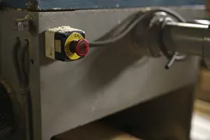 Industrial Building Architecture Stampe: At sawmill. Image of stop button on machine