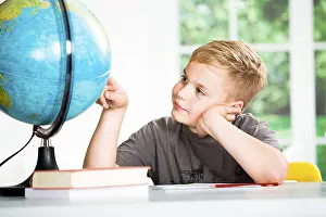 Primary School Homework Stampe: A school boy with a globe