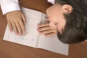 Education Background Image Stampe: Schoolboy sleeping on the table with notebook