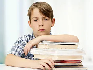 Caucasian Boy Portrait Stampe: Schoolboy with a stack of books, looking serious