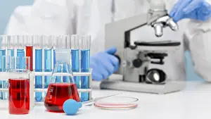 Female Scientist In Lab Stampe: Scientist checking substance with microscope