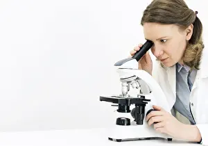 Scientific Experimentation Stampe: Scientist using microscope in laboratory