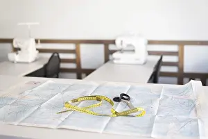 Sewing Workshop Stampe: A sewing workshop featuring essential tools including scissors