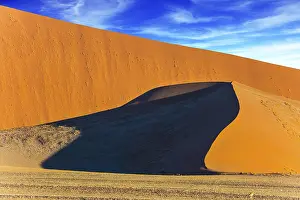 Extreme Tourism Stampe: Sharp border of light and shadow over the crest of the dune