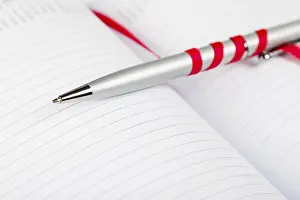 Uninhabited Office Space Decor Stampe: Silver pen on opened notebook with red string