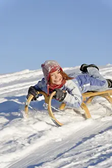 Child In Snow Stampe: Sledding