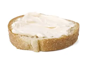 Bread And Dairy Products Stampe: Slice of bread with cheese cream spread on it