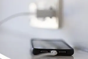 German Power Industry Stampe: A smartphone is charged via a socket