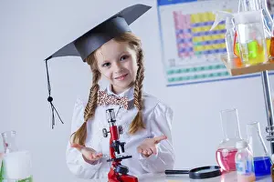 Young Chemist Stampe: Smiling little chemist posing with microscope