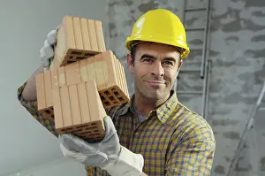 Construction Worker Stampe: Smiling workman holding bricks