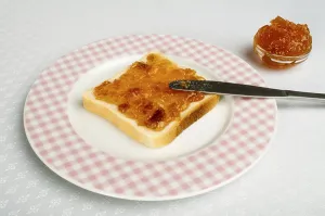 Homemade Breakfast Ideas Stampe: Spread jam on bread with knife