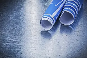 Blue Construction Plans Stampe: Stack of blue construction plans on metallic background building concept