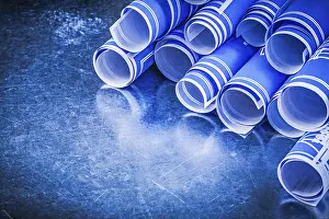 Blue Engineering Drawings Stampe: Stack of blue engineering drawings on metallic background construction concept