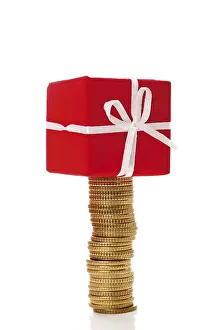 Christmas Gift Stampe: Stack of coins with gift parcel, present on top