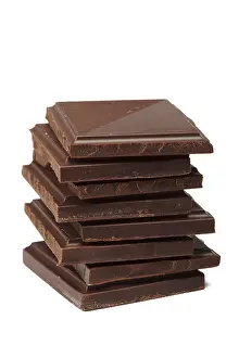 Studio Shot Of Candy Stampe: Stack of dark chocolate isolated on white