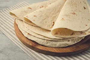 High Angle Shot Of Meal Stampe: A stack of Mexican tortillas, on a gray table