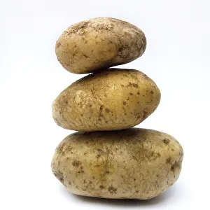 Grocery Items Stampe: A stack of organic potatoes on white background