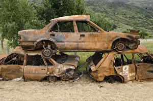 Deserted Junkyard Scene Stampe: Stack of three rusty car wrecks