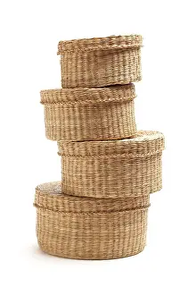 Wicker Baskets Stampe: Stack of various sized wicker baskets isolated on white