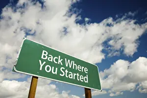 Cloudy Sky Image Stampe: Back where you started road sign with dramatic clouds and sky