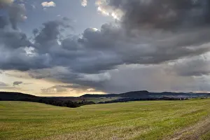 Cloudy Atmospheric Landscape Stampe: Storm clouds over fields