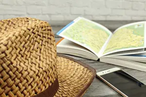 Central Europe Map Stampe: Straw hat, guide book with map