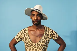 Full Frame Head Shot Stampe: Stylish guy posing in studio against blue background looking at camera