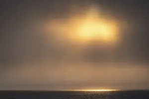 Scandinavian Landscapes Stampe: Sun breaking through clouds, reflection on sea surface