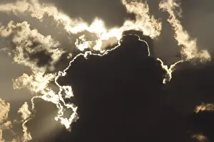 Cloudy Atmosphere Stampe: Sun behind dark storm clouds