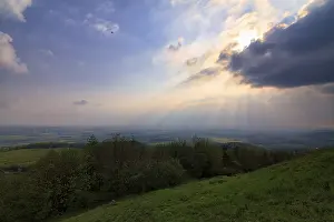 Thunderstorm In Europe Stampe: Sunbeams behind thunderclouds, mountain top