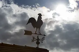 Dramatic Cloud Formations Europe Stampe: Sunlit weather vane in front of dramatic cloud formations