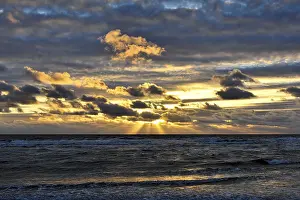 Evening Light In The Netherlands Stampe: Sunset with clouds on the beach