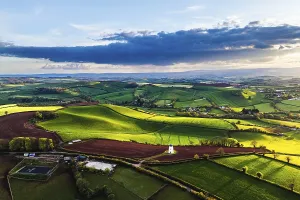 British Countryside Landscape Stampe: Sunset of Devon Windmill over Fields and Farms from a drone