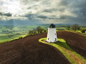 Agricultural Landscape From Above Stampe: Sunset of Devon Windmill over Fields and Farms from a drone