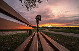 Central Europe Evening Sky Stampe: Sunset at a memorial and a bench in front of it