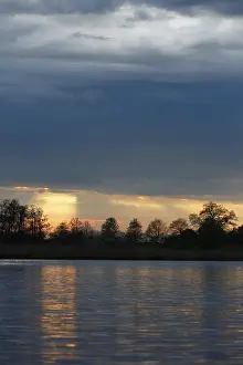 Northern German Water Scenery Stampe: Sunset over the river with dramatic clouds