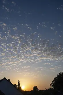 German Evening Sky Stampe: Sunset with small clouds in the evening sky