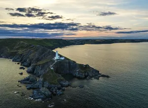Northern Europe Evening Sky Stampe: Sunset over Start Point Lighthouse from a drone