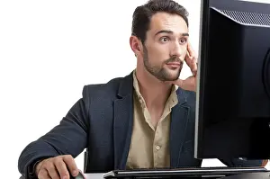 Young Professional Stampe: Surprised man looking at a computer screen