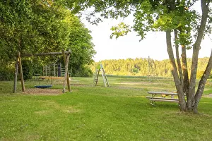 Agricultural Landscape Germany Stampe: A swing and a table in a green clearing with a view of fields