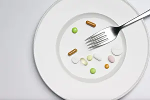 Weight Loss Symbol Stampe: Tablets on a plate with a fork
