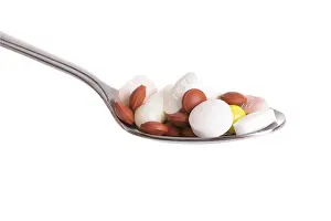Healthcare System Cost Stampe: Tablets on a spoon