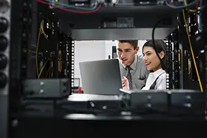 Healthcare Technology Stampe: Team of technicians working together on servers at the data centre