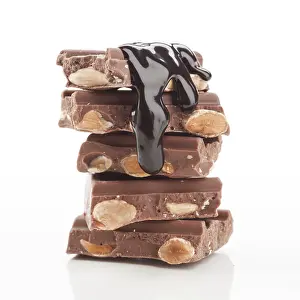 Food Photography Desserts Stampe: A tempting stack of chocolate bars filled with almonds