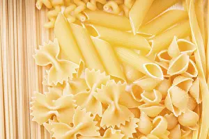 Culinary Background Stampe: Various pasta types as a background on the table